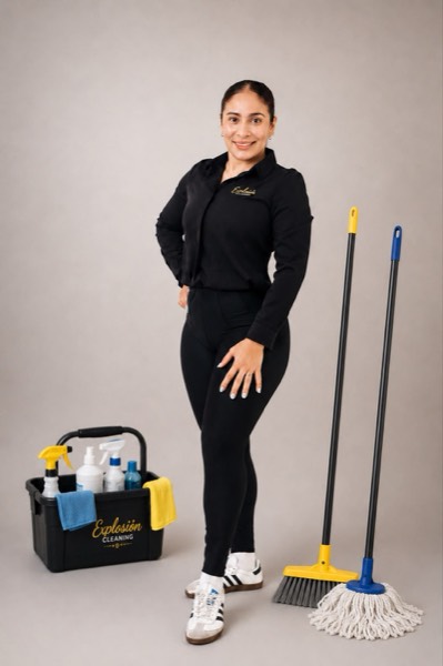 Explosion Cleaning professional team member in branded uniform with cleaning supplies